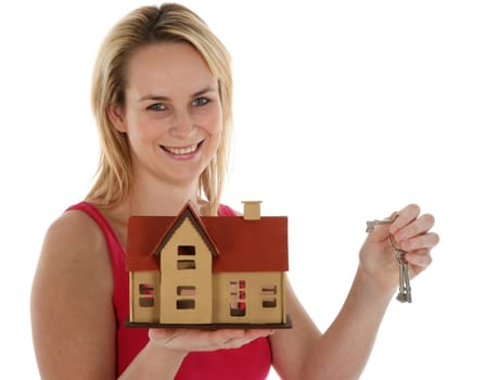 Pretty young blond estate agent sales lady holding out a model house and keys