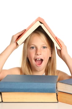 Lovely young school school with pile of books and one on her head
