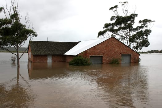 Flooded store room building with water half way up it&#039 s walls