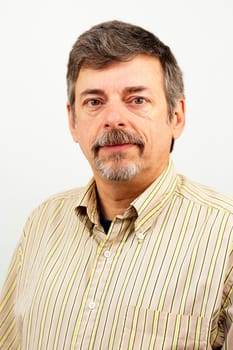 Calm Caucasian man looking towards viewer.
