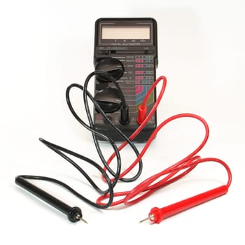 A multimeter with black and red cables attached