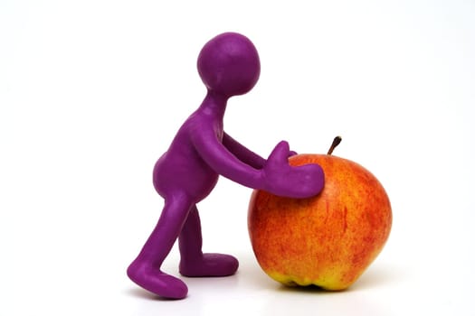 Purple man puppet of plasticine pushing done apple