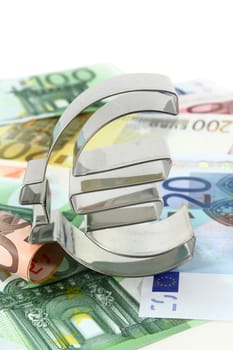 Euro bills and euro signs against white background