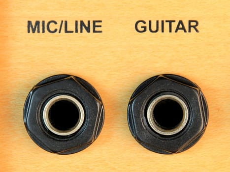 The input sockets for guitar and mic on a sound amplifier