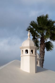 Typical Lanzarote Chimneys and Palm in Puerto Del Carmen on Lanzarote, Canary Islands, Spain