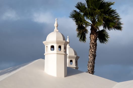 Typical Lanzarote Chimneys and Palm in Puerto Del Carmen on Lanzarote, Canary Islands, Spain