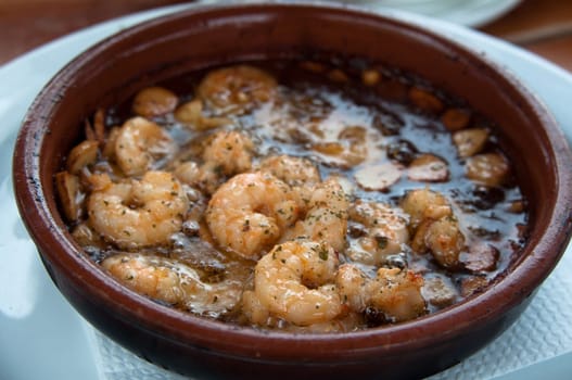 Typical Spanish Tapas - Prawns Fried With Oil And Garlic served in clay cooking pot