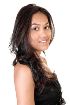 Beautiful smiling Asian girl in a profile portrait shoot with her long curly brunette hair, looking into the camera, on white background.