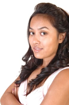 A beautiful Asian woman in a head shoot with long brunette hair, with her arms crossed, over white.