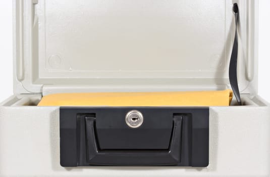 An open fire proof box with a large yellow envelope inside