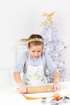 Cute girl baking cookies for Christmas