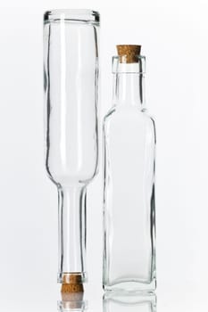 Empty glass bottles with corks isolated on white background