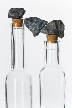 Stones in balance on glass bottles with corks