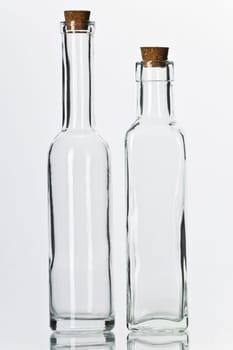 Empty glass bottles with corks isolated on white background