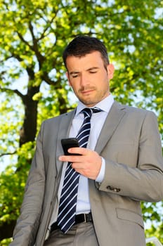 attractive businessman is calling by phone