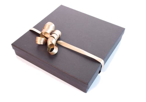 Luxury gift box with a golden bow isolated on a white background