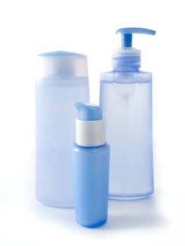blue cosmetic bottles without labels isolated on white background