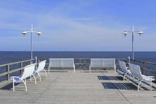 White benches on a pier on the island of Usedom,Baltic Sea,Mecklenburg-Western Pomerania,Germany