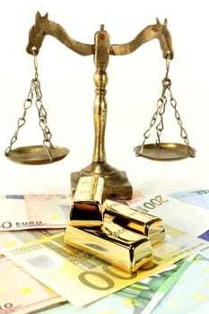 Gold bars and euro notes against light background