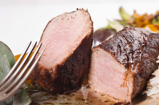 roasted pork tenderloin on grey plate