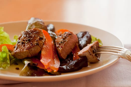 Salad with pork medallions
