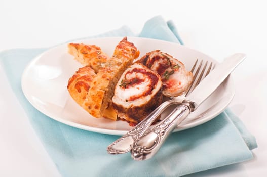 Schnitzel roll on porcelain plate with white bread