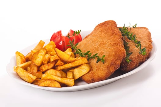 Pork schnitzel with fries on porcelain plate