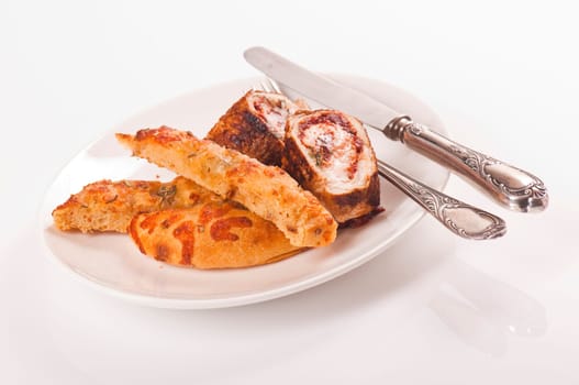 Schnitzel roll on porcelain plate with white bread