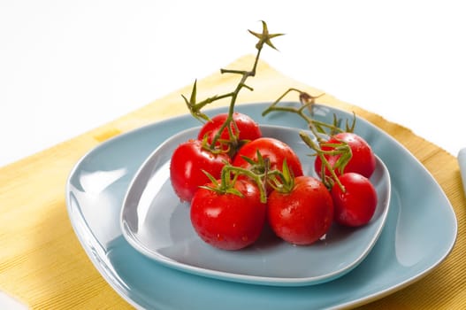 fresh tomatoes on light blue dishes