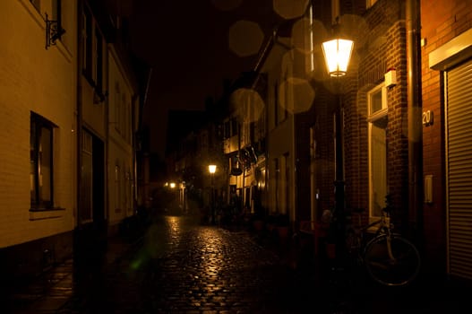 Old town Kempen at night with rain-soaked pavement