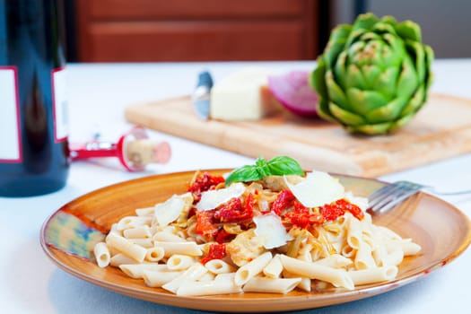 Closeup image of a pasta dish with sundried tomatoes and caramelized onions