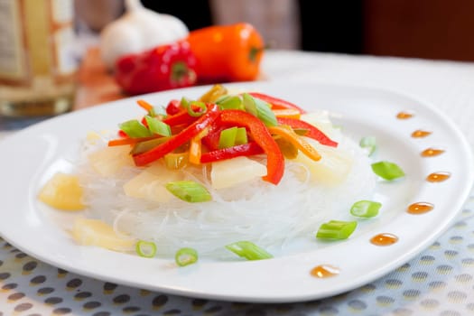 Closeup image of a dish of glass noodles and vegetables