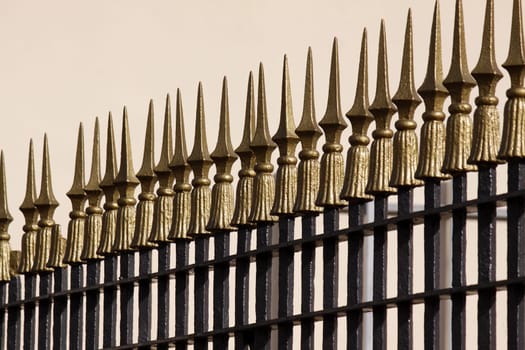 Metal fence with golden tips