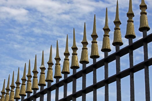 Metal fence with golden tips