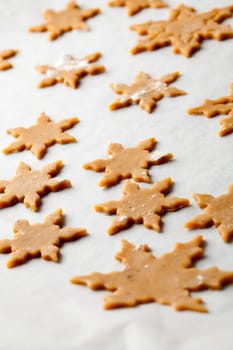 Making gingerbread cookies for Christmas. Gingerbread dough with star shapes.