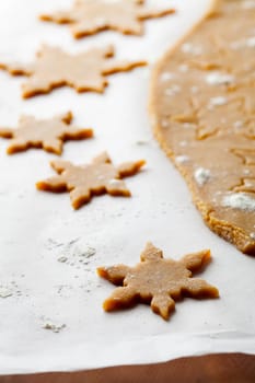 Making gingerbread cookies for Christmas. Gingerbread dough with star shapes.