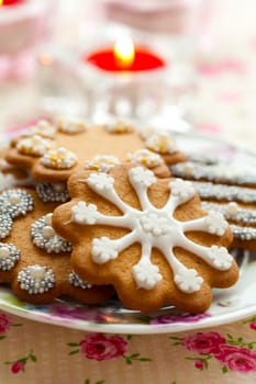 Close-up of delicious decorated Christmas gingerbread cookies with candles