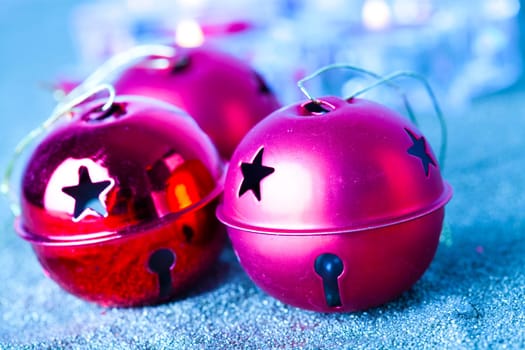 Close-up of jingle bell Christmas baubles with candles