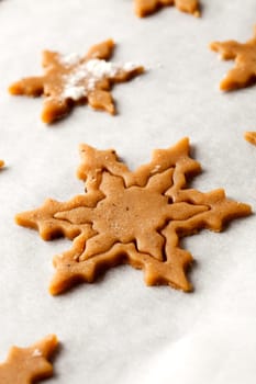 Making gingerbread cookies for Christmas. Gingerbread dough with star shapes.