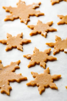 Making gingerbread cookies for Christmas. Gingerbread dough with star shapes.