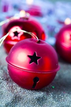 Close-up of jingle bell Christmas baubles with candles