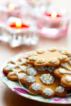 Close-up of delicious decorated Christmas gingerbread cookies with candles
