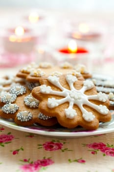 Close-up of delicious decorated Christmas gingerbread cookies with candles