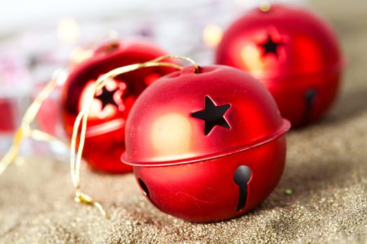 Close-up of jingle bell Christmas baubles with candles