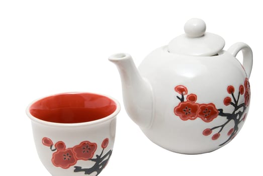Close-up off tea-things in asian style with flowers. Isolated on white.