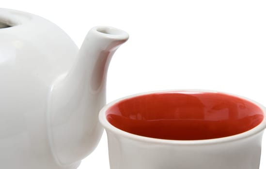 Close-up of teapot and cup on white
