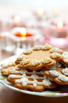 Close-up of delicious decorated Christmas gingerbread cookies with candles