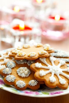 Close-up of delicious decorated Christmas gingerbread cookies with candles