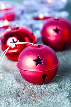 Close-up of jingle bell Christmas baubles with candles