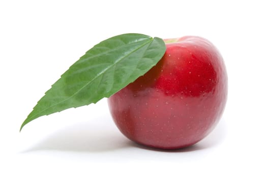 ripe fresh red apple with leaf isolated on white